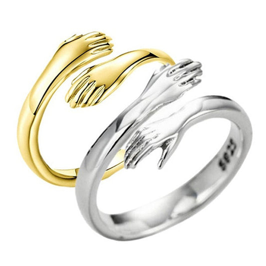 Gold and silver open hand ring on a white background