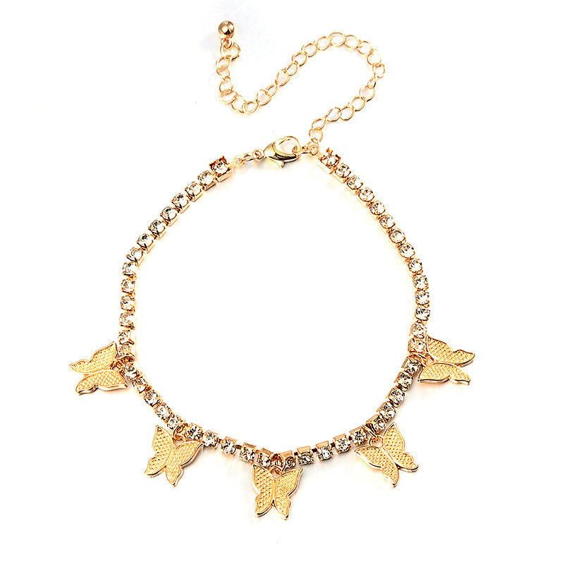 Gold bracelet with butterfly charms on a white background