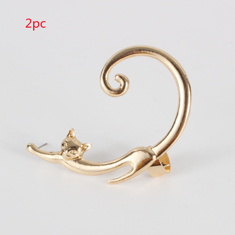 Gold cat-shaped earring on a white background