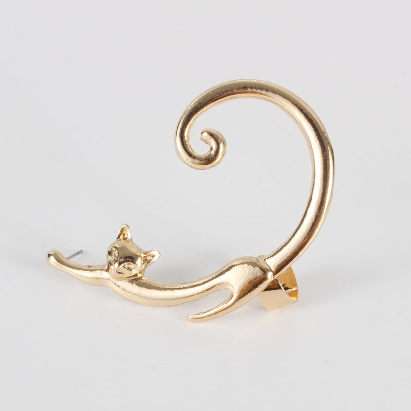 Gold cat-shaped earring on a light gray background