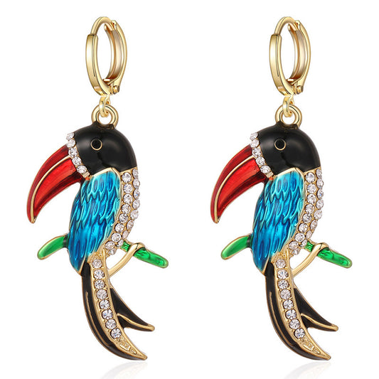 Colorful parrot-shaped earrings with gold accents on a white background