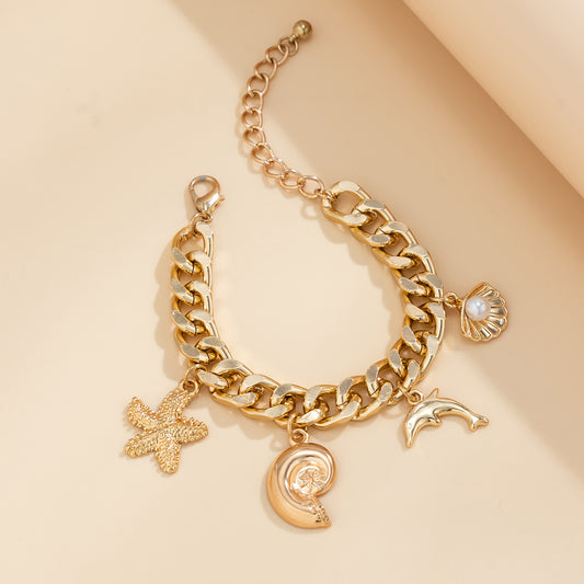 Gold Boho Ocean Charm Bracelet on cloth