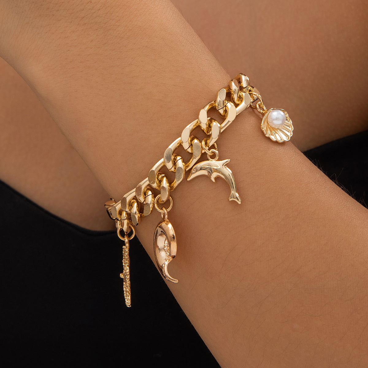 Gold Boho Ocean Charm Bracelet on woman's wrist