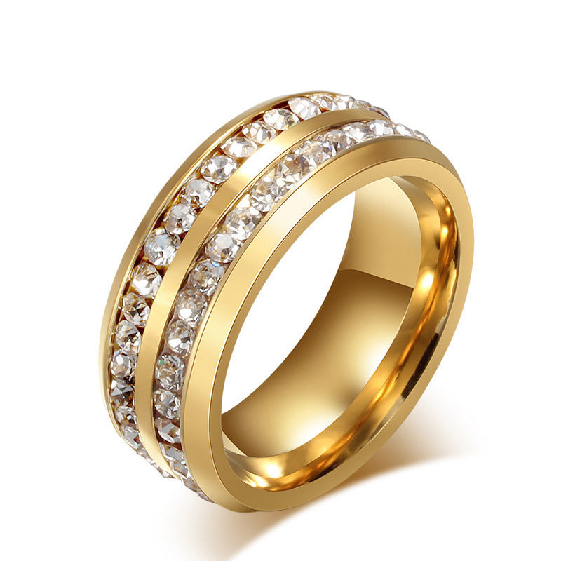 Gold ring with diamond accents on a white background