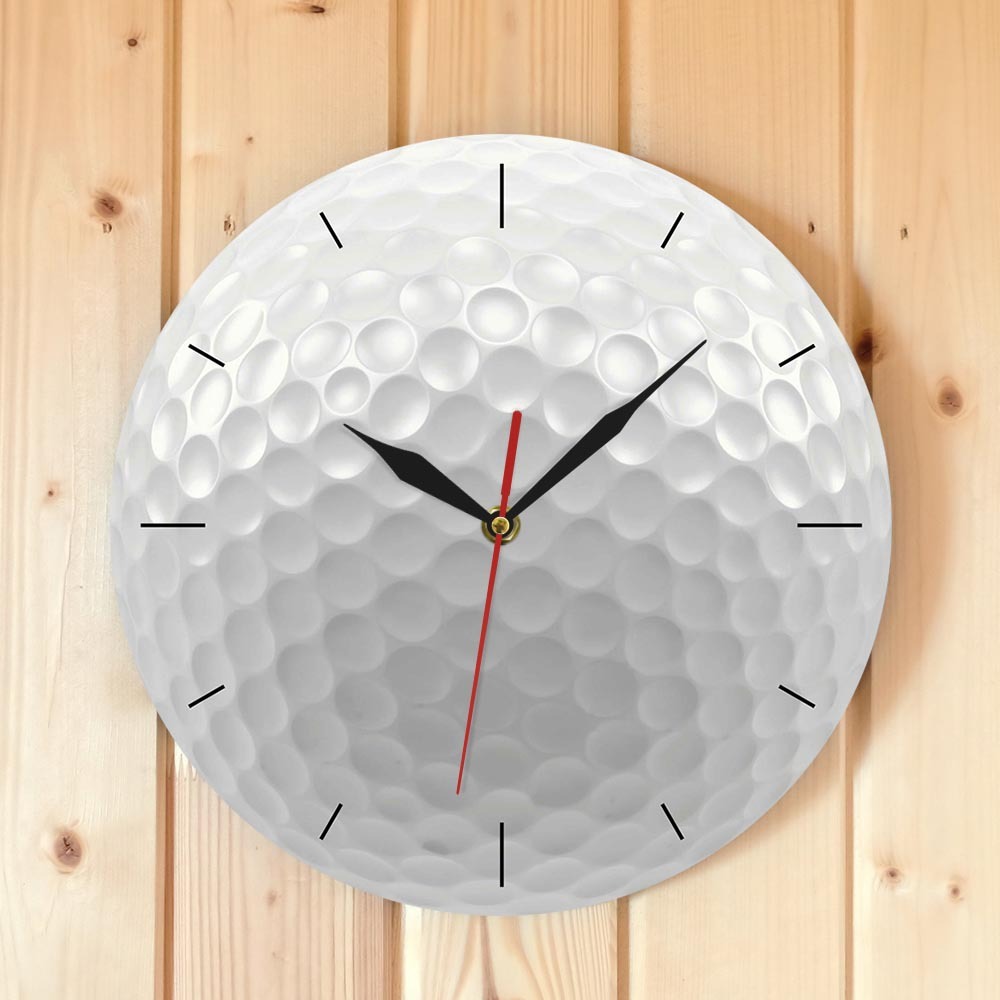 Wall clock designed like a golf ball on a wooden background
