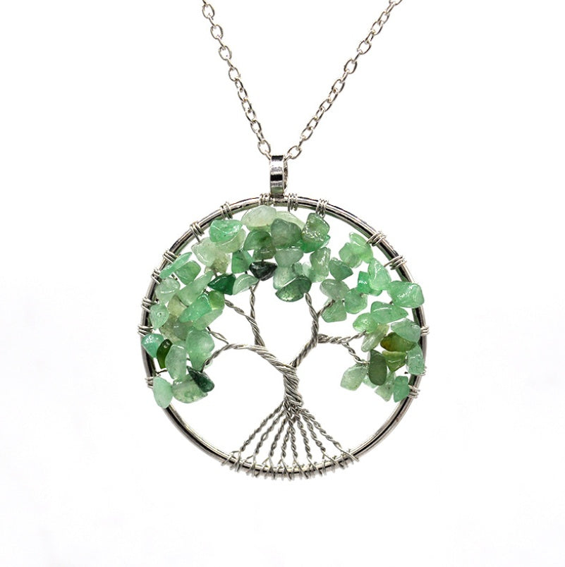 Necklace with a tree-shaped pendant made of green stones on a white background