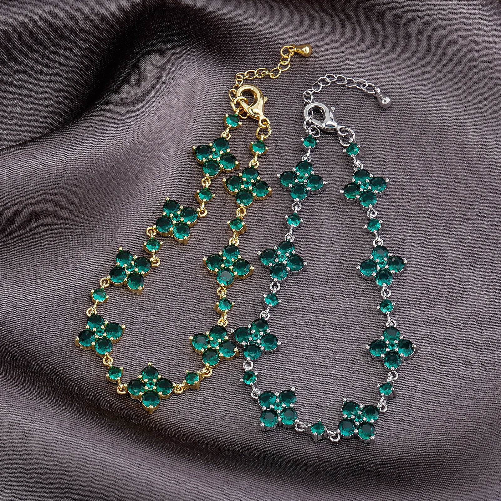 Two green gemstone bracelets on a gray fabric background