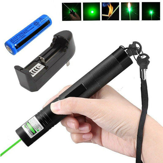 Green laser pointer held in a hand with battery and charger, surrounded by green laser light effects.