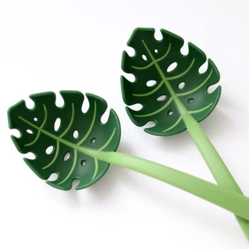 Two green leaf-shaped objects on a white background
