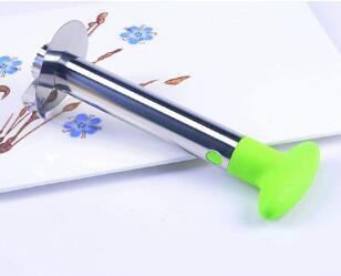 Stainless steel kitchen tool with green handle on a white background