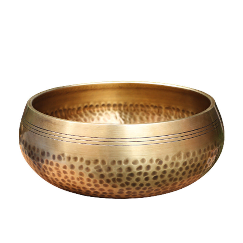 Handmade-Nepalese-singing-bowl-for-chakra Brass bowl with a textured surface on a white background