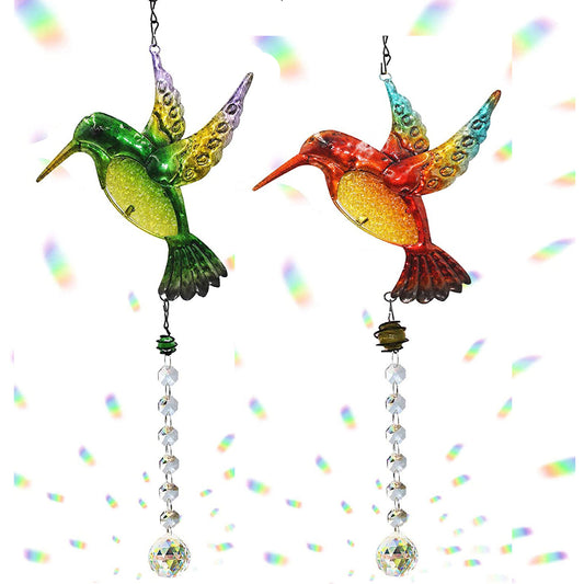 Two colorful hummingbird-shaped wind chimes on a white background with rainbow sparkles.