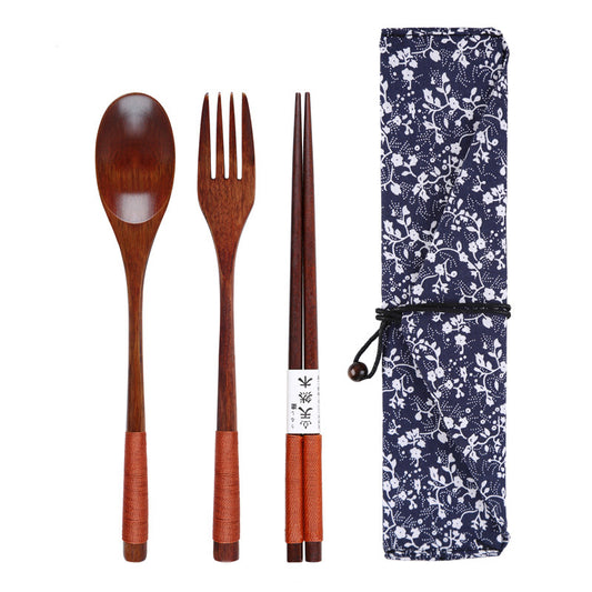 Wooden spoon, fork, and chopsticks set with a floral-patterned case on a white background