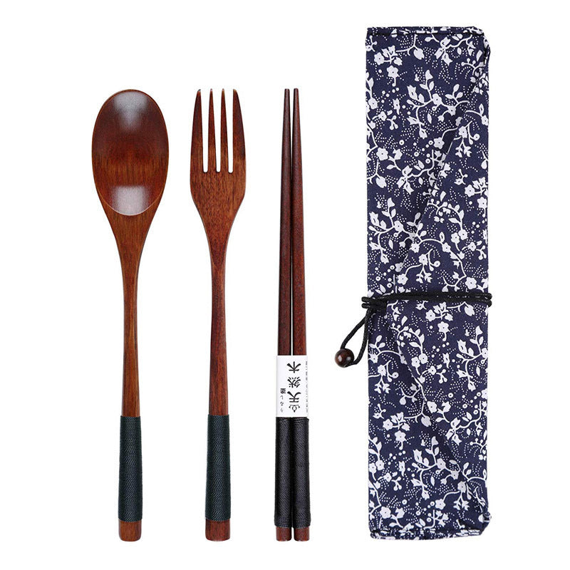 Wooden spoon, fork, and chopsticks with a floral-patterned case on a white background