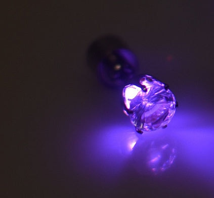 Purple LED light bulb on a dark background