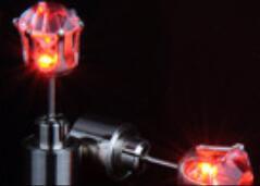 Close-up of a motorcycle tail light with a dark background