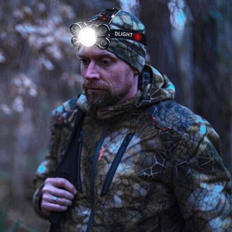 Man wearing a headlamp with 'DLIGHT' branding in a forest setting
