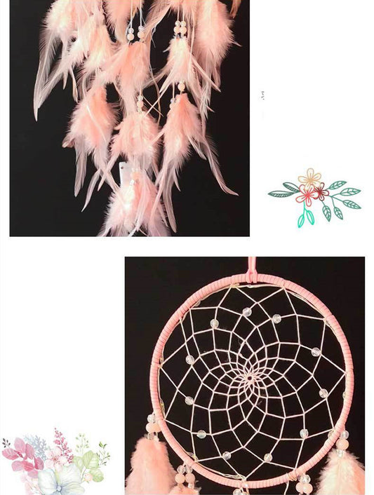 Pink feather dreamcatcher with decorative elements on a black background