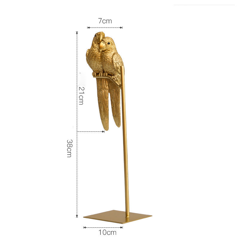 Gold parrot figurine on a stand with dimensions indicated