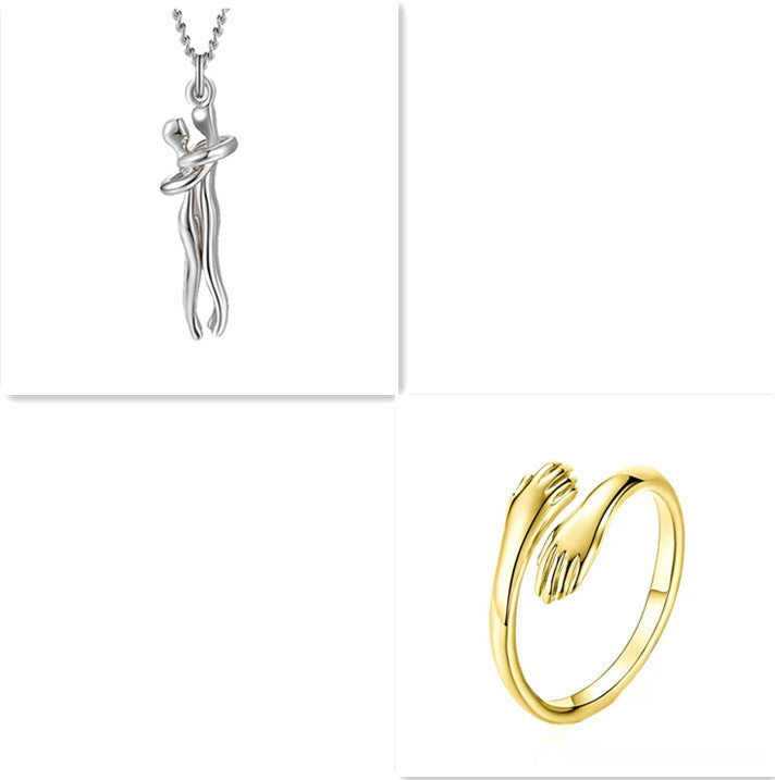 Love Hug necklace Gold ring and silver pendant on a white background