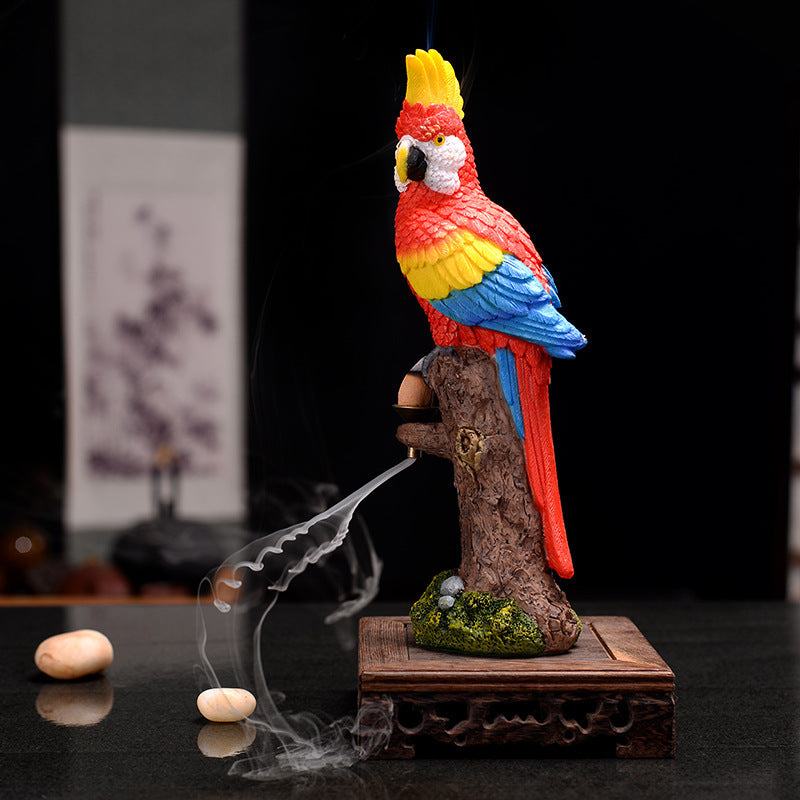 Colorful parrot incense burner with smoke on a dark background