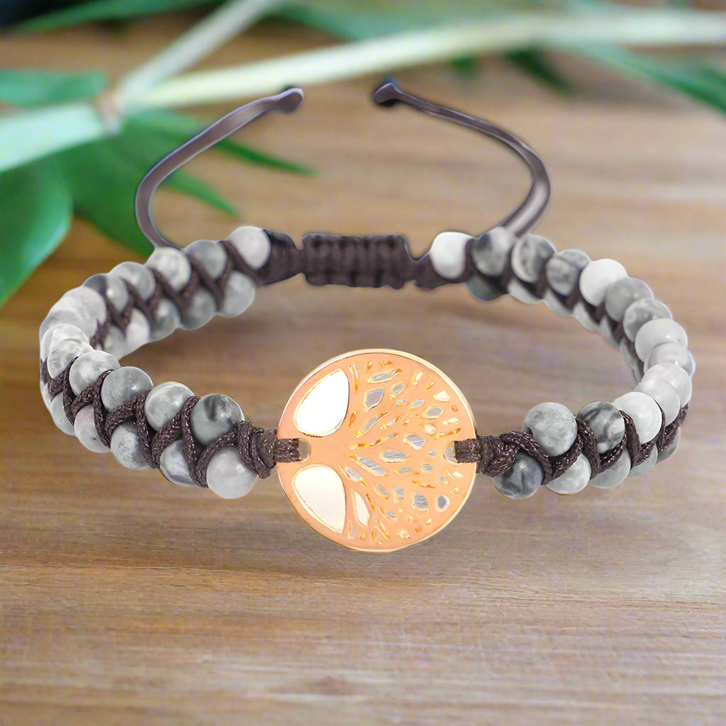 Bracelet with tree of life charm and beaded design on a white background