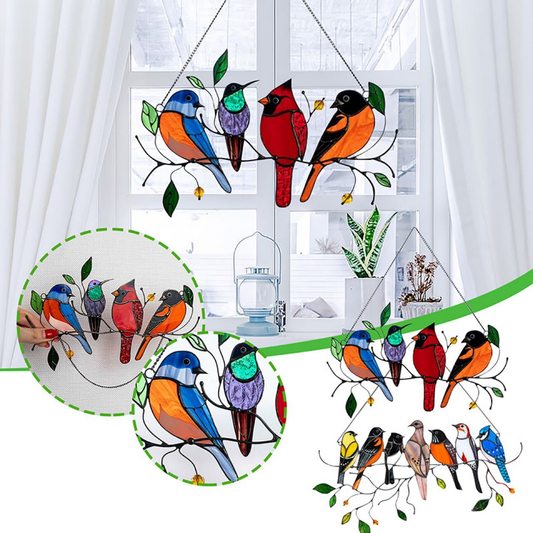 Multiple bird sun catchers hanging in a window