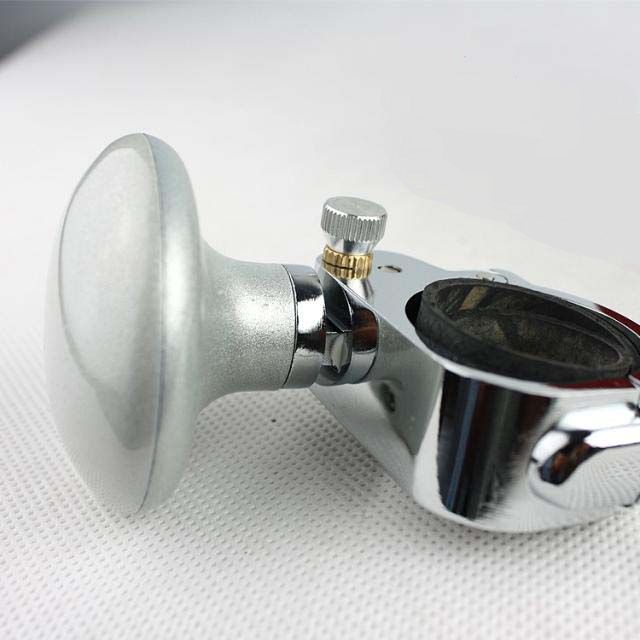 “Silver steering wheel spinner knob with stainless clamp shown from side angle”