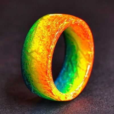 Multicolored ring with a gradient of orange, yellow, green, and blue on a dark background