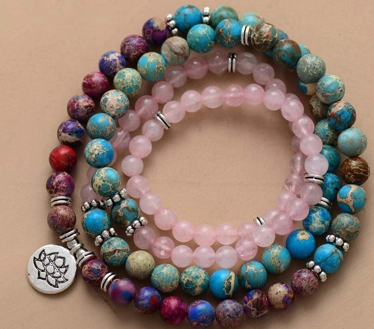 Stack of colorful beaded bracelets with a beige background