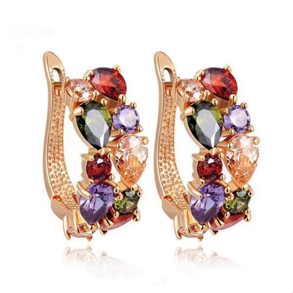 Multicolored gemstone earrings with gold setting on a white background
