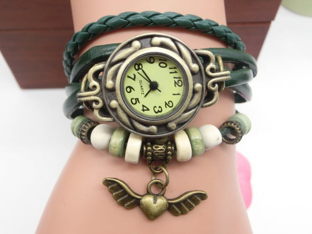 Bracelet with vintage-style watch and angel wing charm on wrist