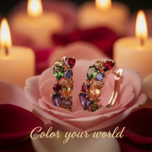 Multicolored gemstone earrings on a pink rose