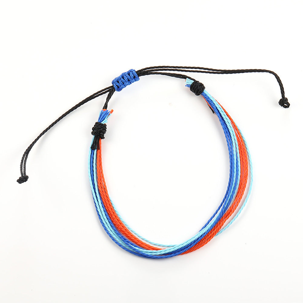 Multicolored bracelet with black cord on a white background