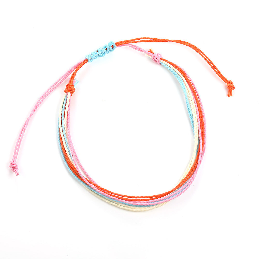 Colorful string bracelets on a white background