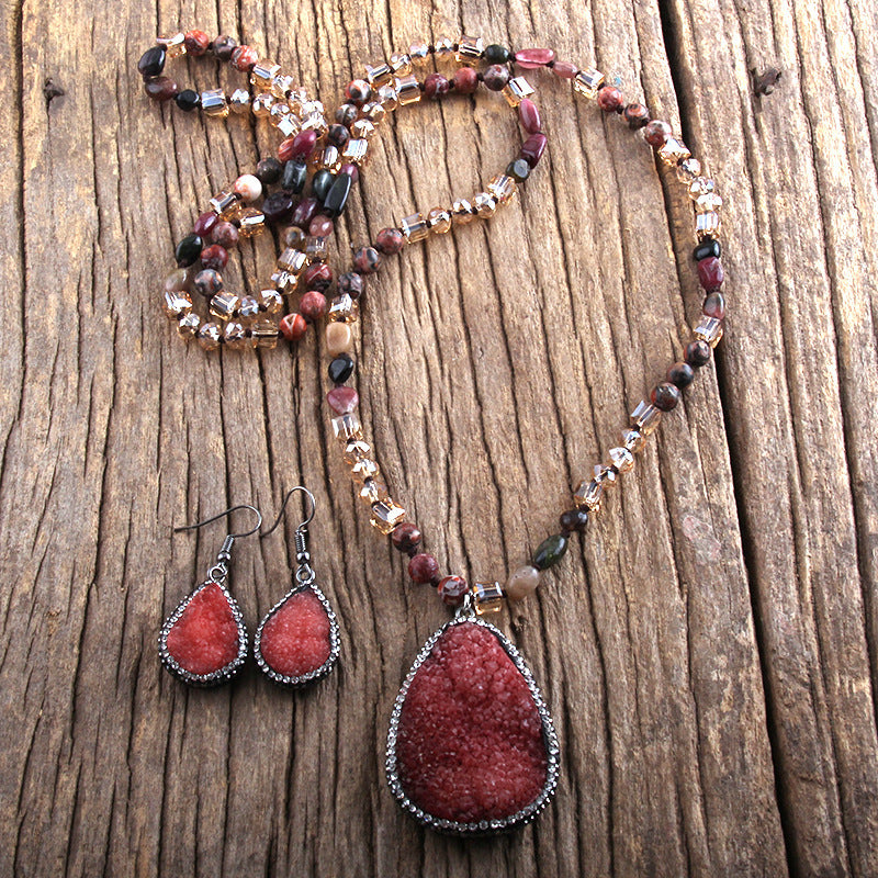 Jewelry set with necklace and earrings on a wooden surface