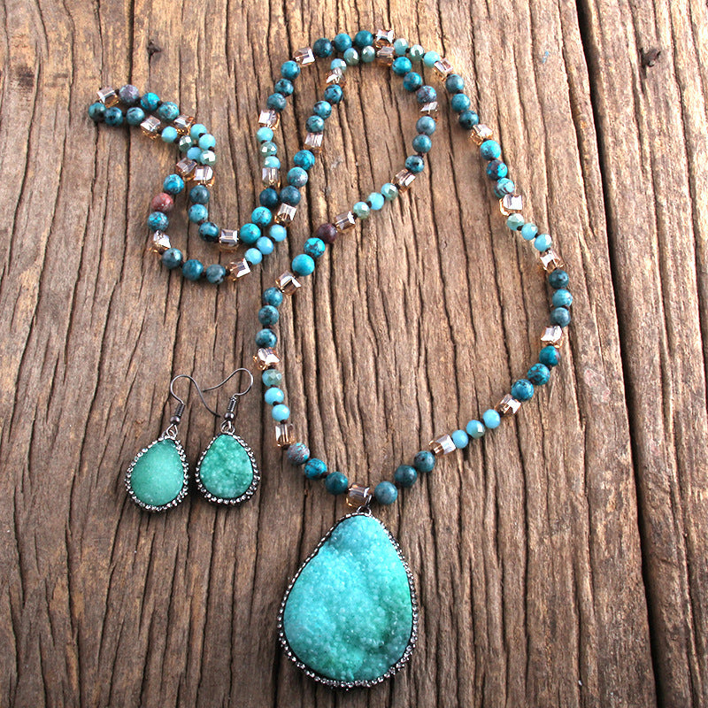 Turquoise necklace and earrings on a wooden surface