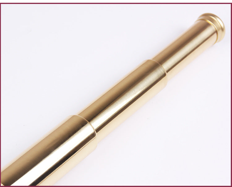 Gold telescope on a white background