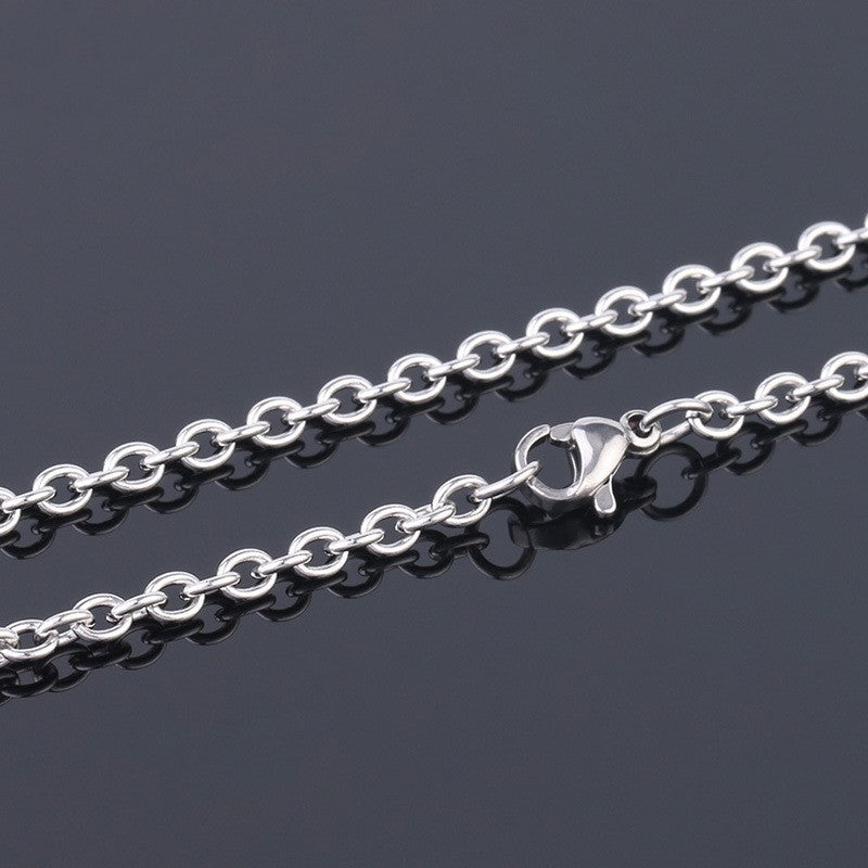 Silver chain necklace on a dark background