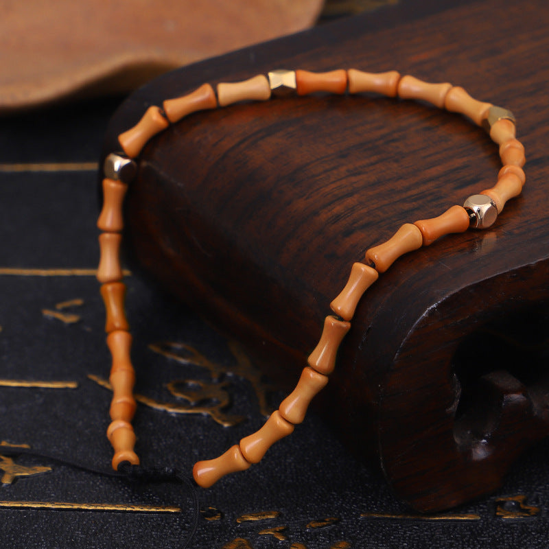 Wooden beaded bracelet on a dark textured surface