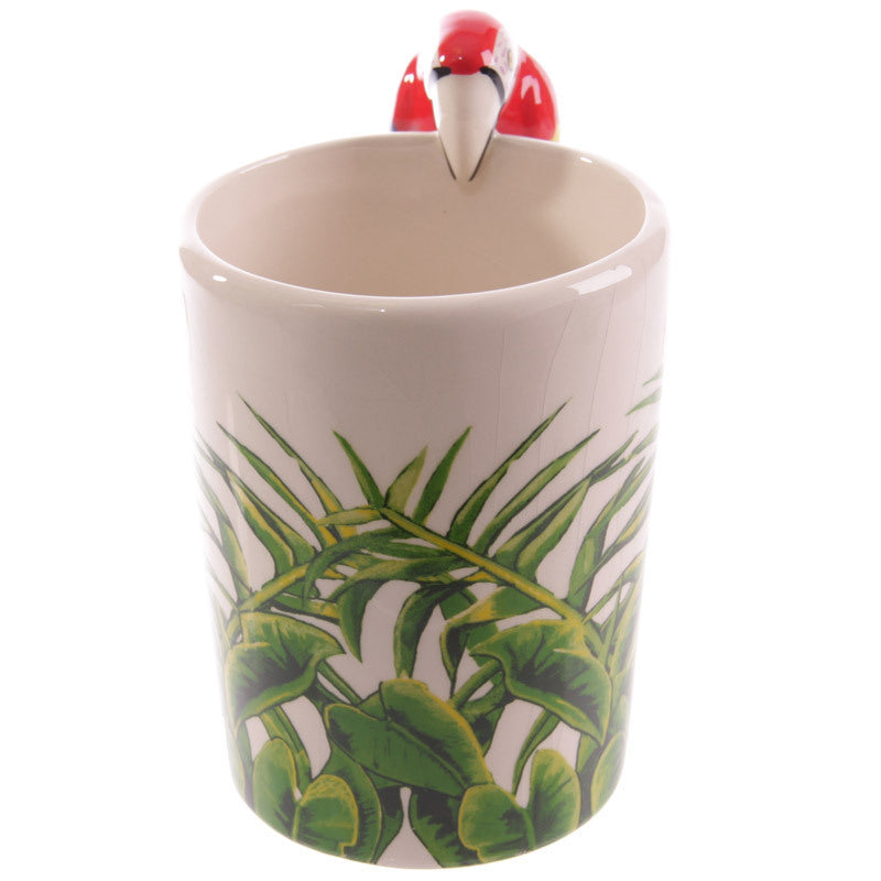 Mug with a flamingo design on top and leaf pattern on the side, on a white background