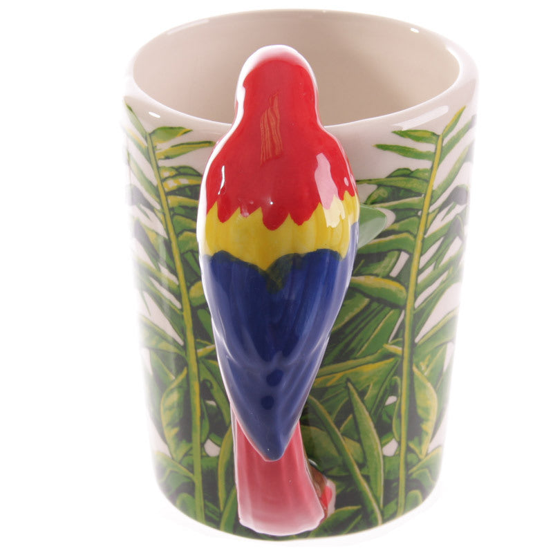 Mug with a colorful parrot-shaped spoon holder on a leaf-patterned background