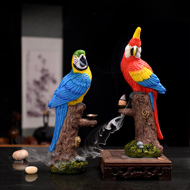 Two colorful parrot figurines with smoke on a dark background