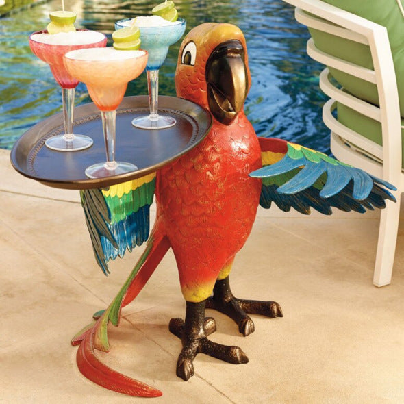 Parrot-shaped table with drinks by a poolside