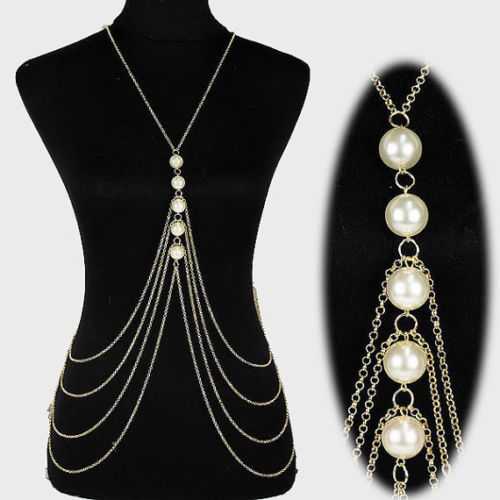 Pearl and chain body chain on a black mannequin with close-up on white background