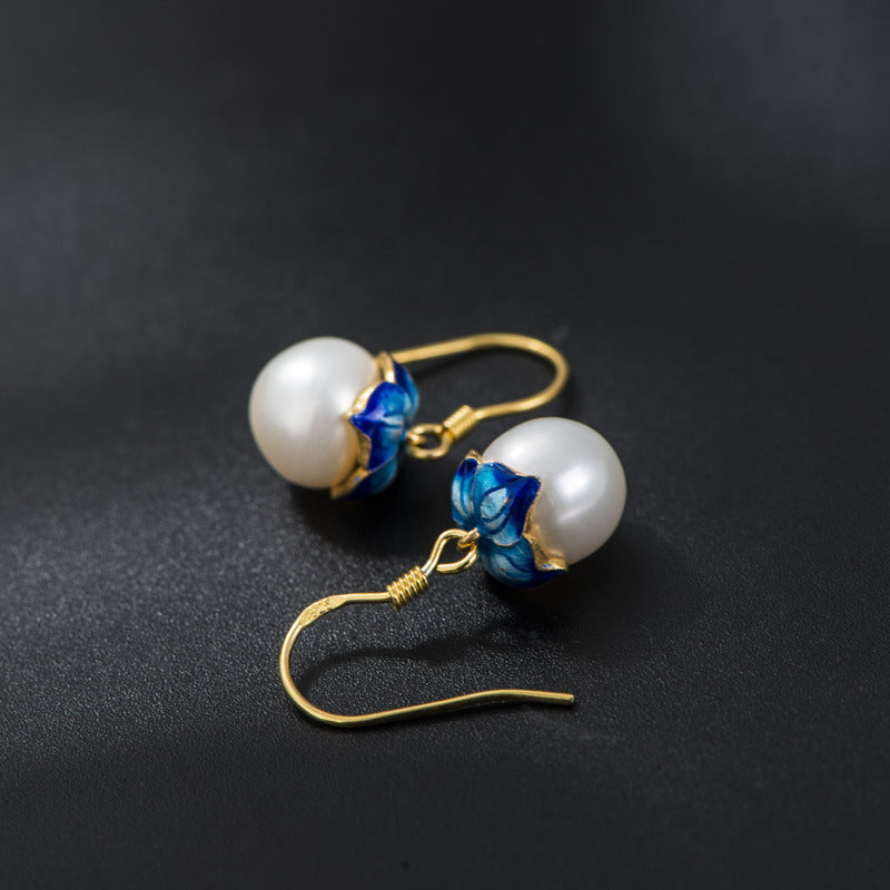Pearl earrings on black background