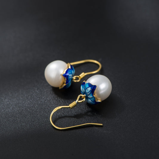 Pearl earrings on black background