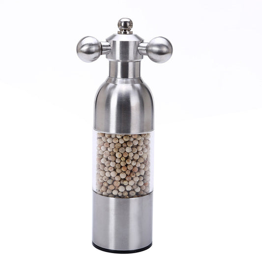 Stainless steel pepper mill with pepper inside on a white background
