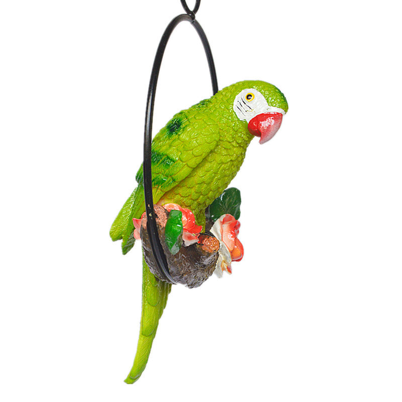 Green parrot figurine with red beak on a white background