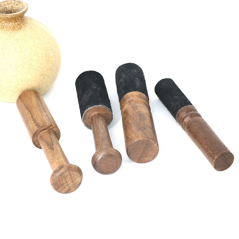 Set of wooden rolling pins with black ends on a white background